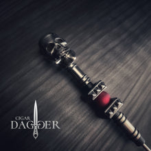 Load image into Gallery viewer, kingpin cigar dagger in red with silver, gunmetal and red accents plus a cigar smoking skull close up angled view