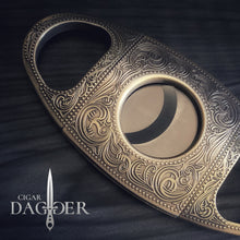 Load image into Gallery viewer, cigar cutter in antique brass with engraved design close up